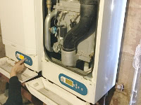 An engineer repairing a Commercial Boiler