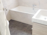 A stunning bathroom with a walk in shower, bath and wash hand basin fitted by our bathroom fitters.