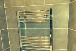 New bathroom installation showing the new chrome towel radiator.