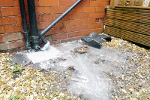 Blocked gully in a property causing kitchen to over spill into garden
