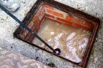 Blocked man hole causing the drains in a property to back up