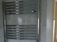 New chrome towel radiator installed in a customers bathroom.
